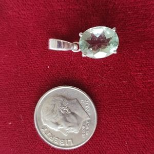 Silver pendant with light green gemstone